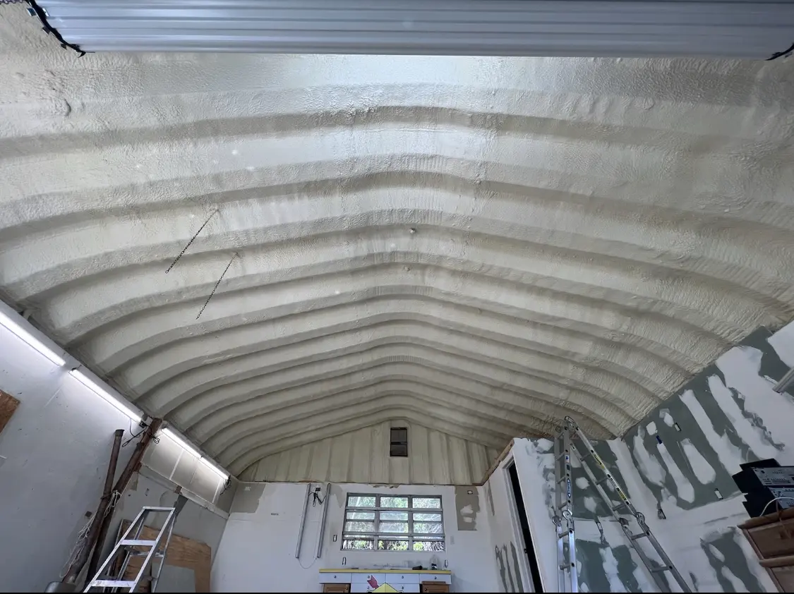 Spray polyurethane foam applied to the underside of a metal roof deck in Andrews